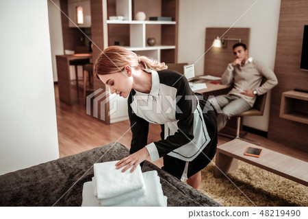 Beautiful hotel maid bringing white towels in the morning 48219490