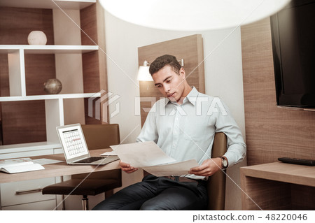 Busy businessman working on schedule for his employees Busy businessman working on schedule for his employees 48220046