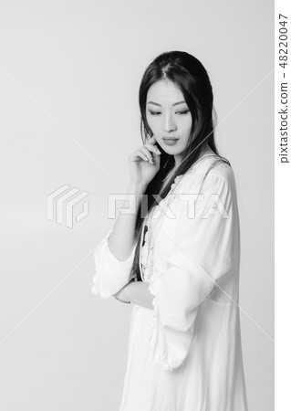 beautiful asian woman in white shirt posing in studio. 48220047