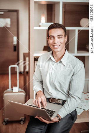Cheerful businessman feeling excited before important negotiation Cheerful businessman feeling excited before important negotiation 48220048