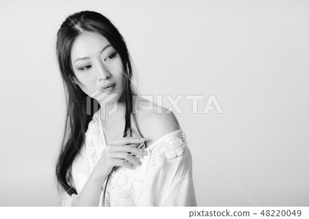 beautiful asian woman in white shirt posing in studio. beautiful asian woman in white shirt posing in studio. 48220049