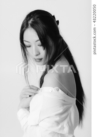 beautiful asian woman in white shirt posing in studio. beautiful asian woman in white shirt posing in studio. 48220050