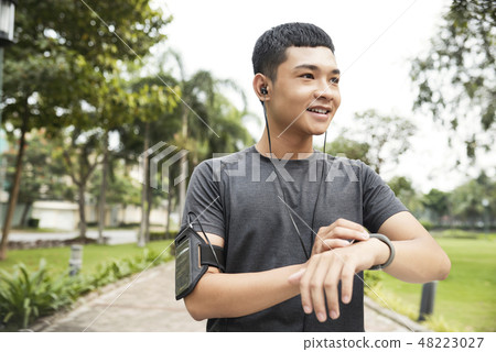 Man setting fitness tracker 48223027