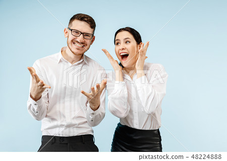 Excited happy young couple looking at camera with delight amazed by unbelievable great sale 48224888