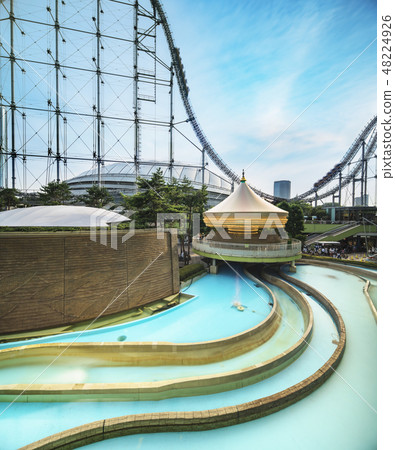 Merry-go-round long exposure shooting at the LaQua amusement facility in Korakuen spreading in the summer blue sky Merry-go-round long exposure shooting at the LaQua amusement facility in Korakuen spreading in the summer blue sky 48224926