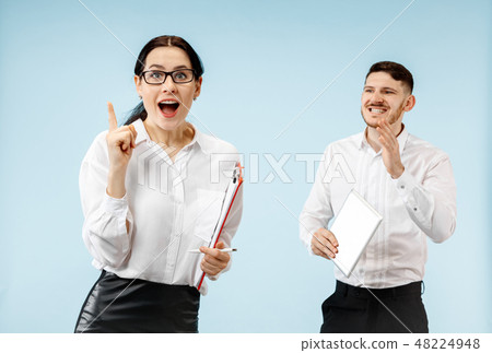 The surprised business man and woman smiling on a gray background 48224948