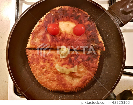 Two appetizing Caucasian chebureks in a pan 48225303