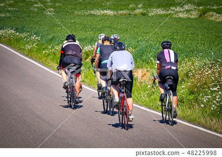 Group of cyclist on the road at springtime Group of cyclist on the road at springtime 48225998
