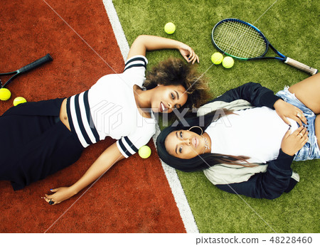 young pretty girlfriends hanging on tennis court, fashion stylish dressed swag, best friends happy 48228460