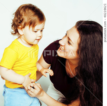 young mother with little cute daughter on white, happy smiling family inside isolated adorable young mother with little cute daughter on white, happy smiling family inside isolated adorable 48228621