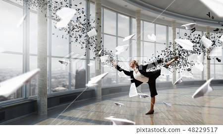 Dancing businesswoman in office Dancing businesswoman in office 48229517