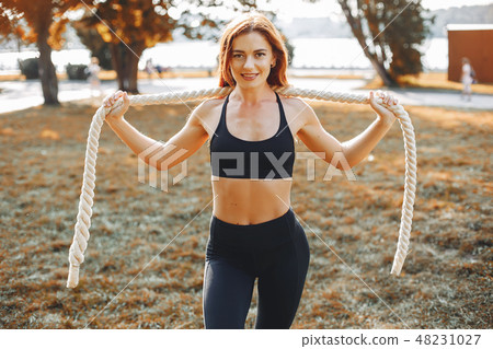 Sports girl in a morning summer park Sports girl in a morning summer park 48231027