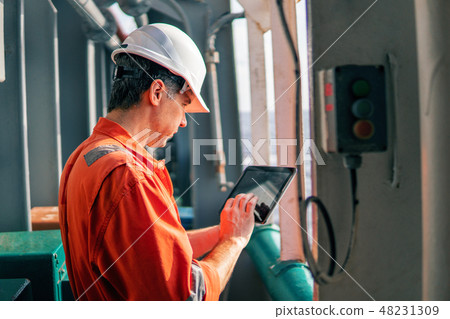 chief officer or captain on deck of vessel or ship watching digital tablet 48231309