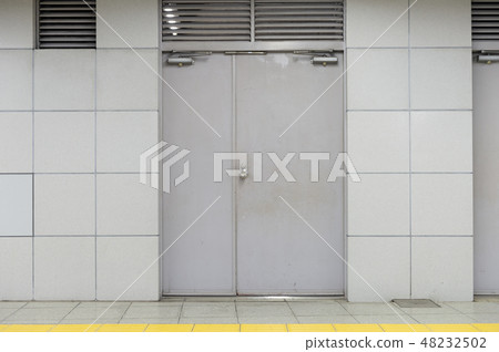 sidewalk by street wall & door sidewalk by street wall & door 48232502