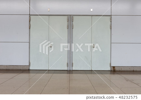 sidewalk by street wall & door sidewalk by street wall & door 48232575