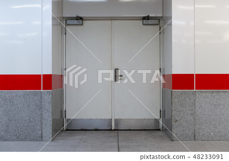 sidewalk by street wall & door sidewalk by street wall & door 48233091