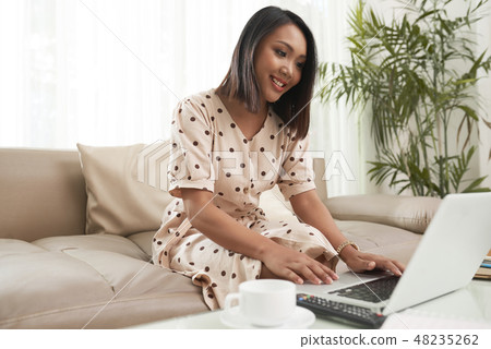 Pretty woman working on laptop Pretty woman working on laptop 48235262
