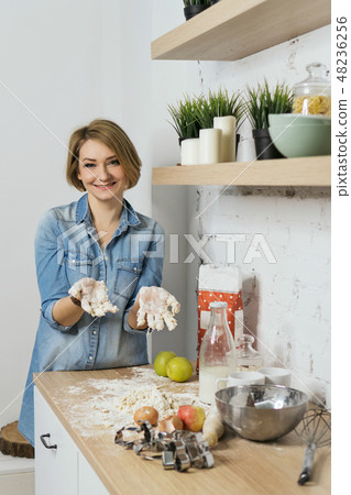 Girl preparing food in kitchen Girl preparing food in kitchen 48236256