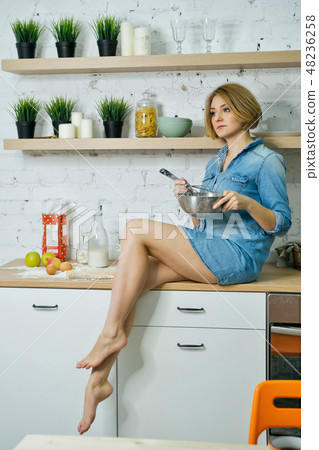 Girl preparing food in kitchen Girl preparing food in kitchen 48236258