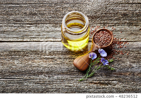 Flax oil on wooden board Flax oil on wooden board 48236512