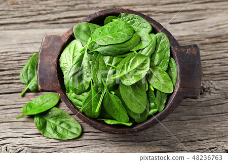 Spinach leaves on wooden background Spinach leaves on wooden background 48236763