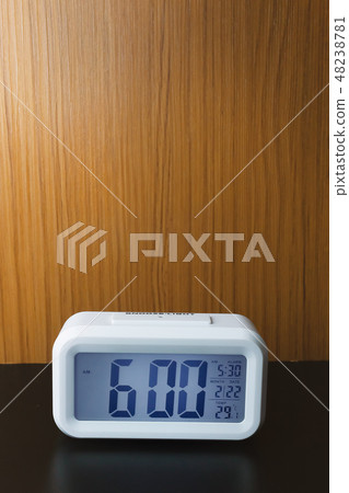The digital alarm clock  6:00 close up image. 48238781