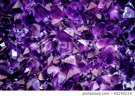 Amethyst purple crystal. Mineral crystals in the natural environment. Texture of precious and Amethyst purple crystal. Mineral crystals in the natural environment. Texture of precious and 48240224
