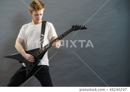 Man playing on electric guitar Man playing on electric guitar 48240297