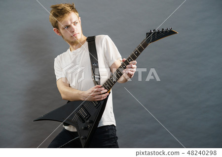 Man playing on electric guitar Man playing on electric guitar 48240298