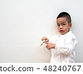 sick boy with thermometer on white background 48240767