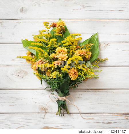 Autumn bouquet of yellow wildflowers on board. Autumn bouquet of yellow wildflowers on board. 48241487