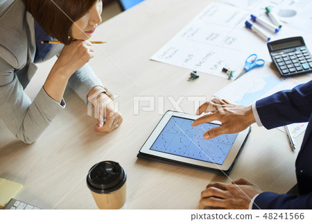 Business executives discussing statistics Business executives discussing statistics 48241566