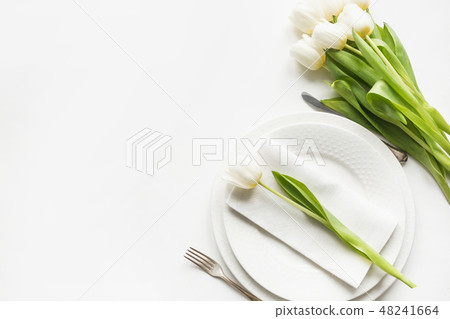 Easter dinner. Table setting with white tulip. Easter dinner. Table setting with white tulip. 48241664