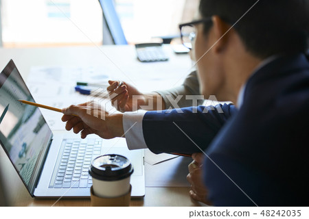 Business partners discussing financial data 48242035
