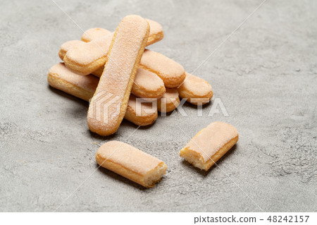 Italian Savoiardi ladyfingers Biscuits on concrete backgound Italian Savoiardi ladyfingers Biscuits on concrete backgound 48242157