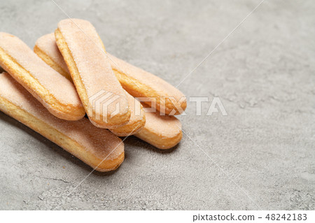 Italian Savoiardi ladyfingers Biscuits on concrete backgound Italian Savoiardi ladyfingers Biscuits on concrete backgound 48242183