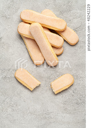 Italian Savoiardi ladyfingers Biscuits on concrete backgound Italian Savoiardi ladyfingers Biscuits on concrete backgound 48242229