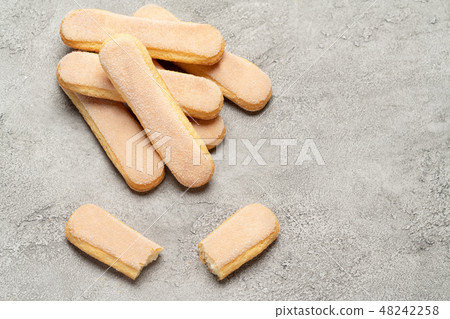 Italian Savoiardi ladyfingers Biscuits on concrete backgound Italian Savoiardi ladyfingers Biscuits on concrete backgound 48242258