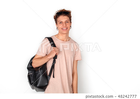 Teenager with earrings carrying backpack studio standing isolated on white looking camera happy 48242777