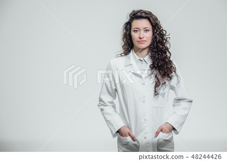 Horizontal portrait of a young pretty doctor's girl. Smiling, looking straight into the camera. On a Horizontal portrait of a young pretty doctor's girl. Smiling, looking straight into the camera. On a 48244426