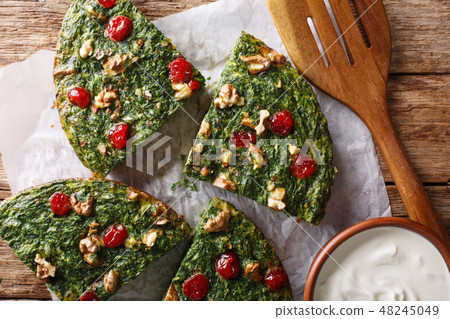 Persian kuku sabzi omelette of herbs, eggs and nut 48245049