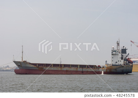 large cargo ship moves towards the exit large cargo ship moves towards the exit 48245578