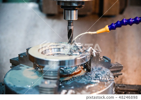 Drilling machine makes a hole in the metal product 48246898