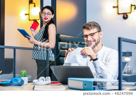 Delighted bearded man opening envelope with letter Delighted bearded man opening envelope with letter 48247099
