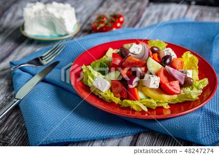 Greek salad of fresh cucumber, tomato, sweet pepper, lettuce, red onion, feta cheese and olives with Greek salad of fresh cucumber, tomato, sweet pepper, lettuce, red onion, feta cheese and olives with 48247274