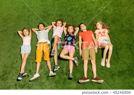 Group of happy children playing outdoors. 48248800