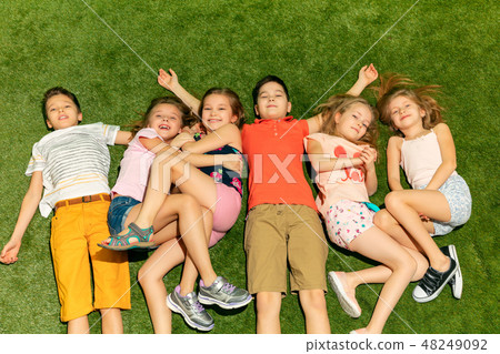 Group of happy children playing outdoors. 48249092