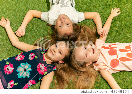 Group of happy children playing outdoors. 48249104