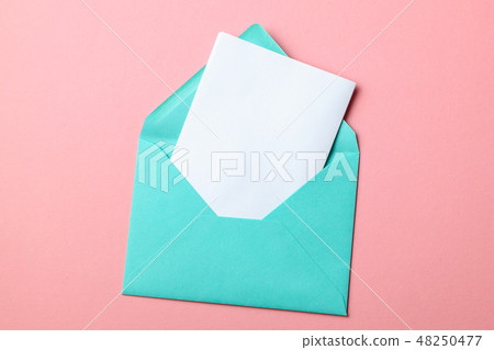 Green envelope and blank letter on pink background Green envelope and blank letter on pink background 48250477