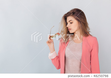 blonde woman in pastel casual jacket posing in studio. blonde woman in pastel casual jacket posing in studio. 48250798